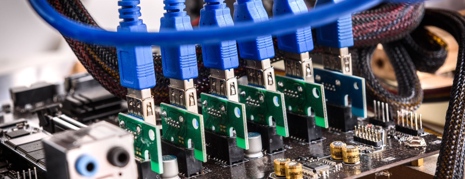 six PCI x1 to USB 3.0 converters with blue cables connected