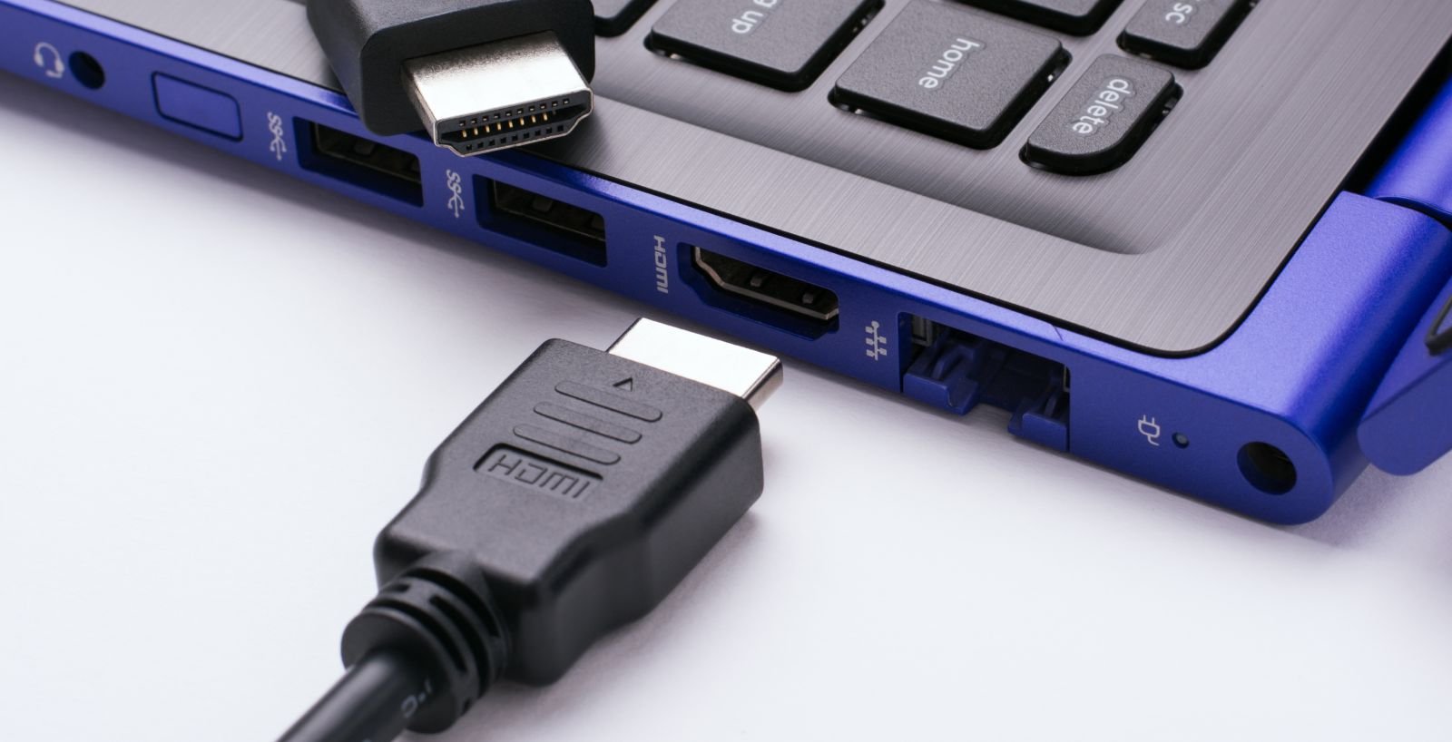 HDMI cable lying next to the blue laptop