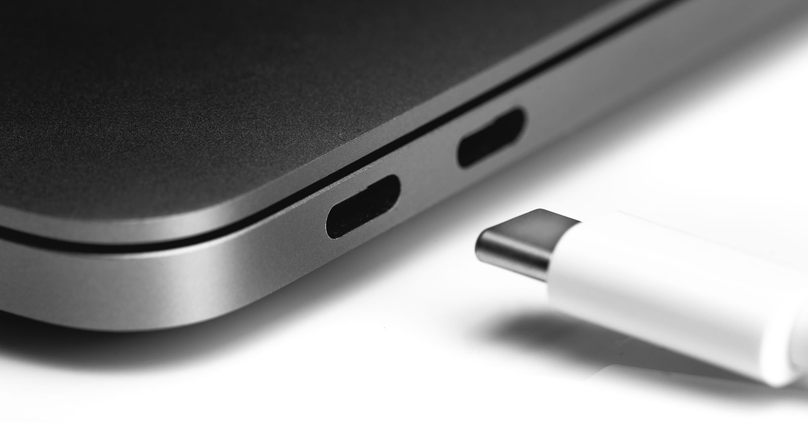 the person connects the USB type C plug to the ultrabook