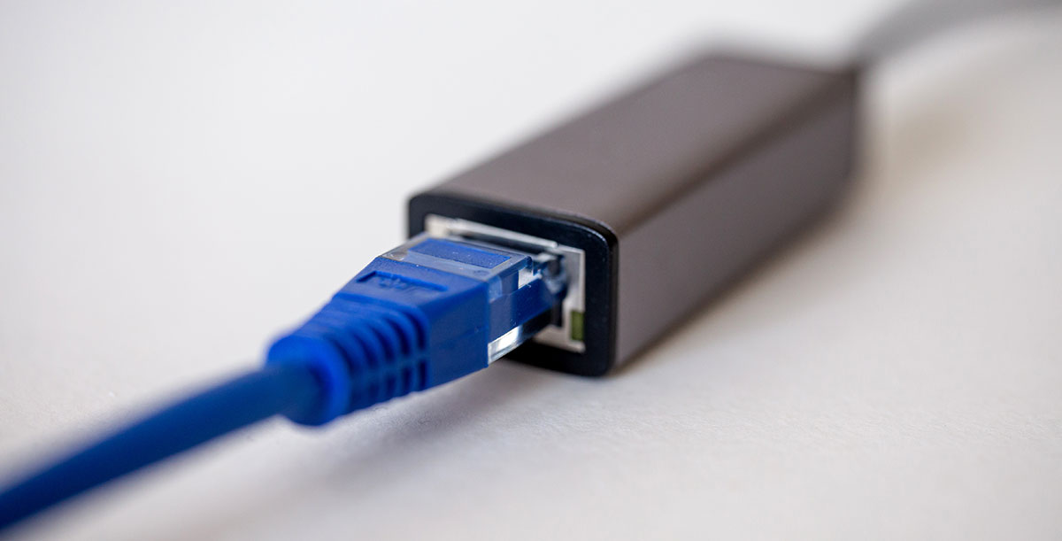 close-up on end of Ethernet cable plugged into network adapter