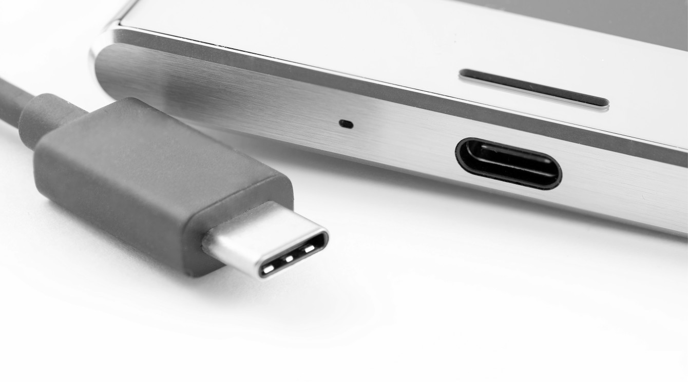 USB type C cable plug next to the smartphone